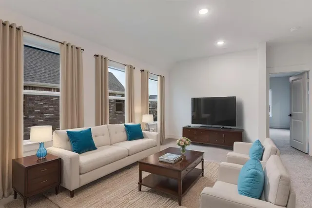 a living room with furniture and a flat screen tv