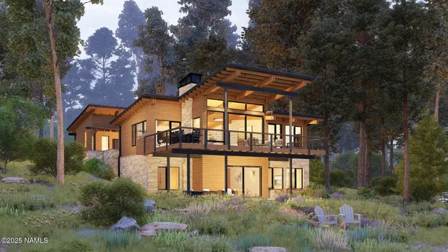 a view of a house with a small yard plants and large tree