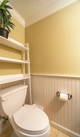 a white toilet sitting next to a bathroom sink