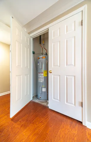 a view of empty room with wooden floor and entryway