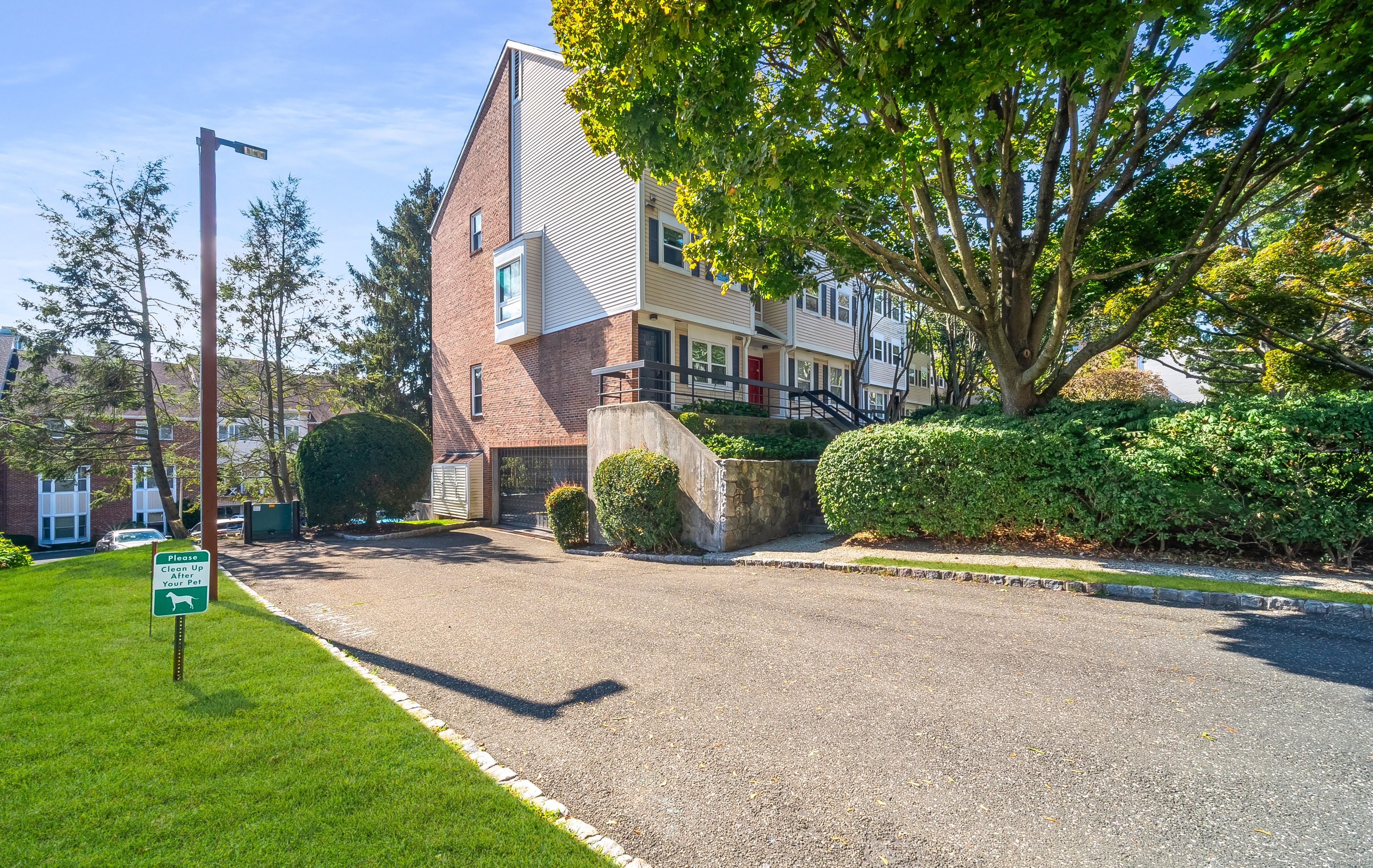 109 Highland Road, Unit 109 Stamford, CT 06901 - Photo 3 of 37 a view of a house with a yard and large trees