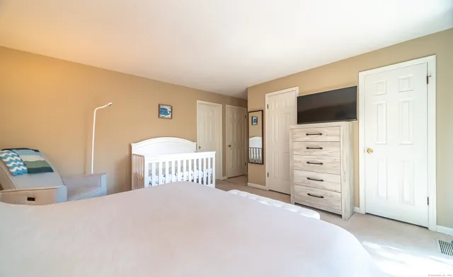 a bedroom with a bed and a television