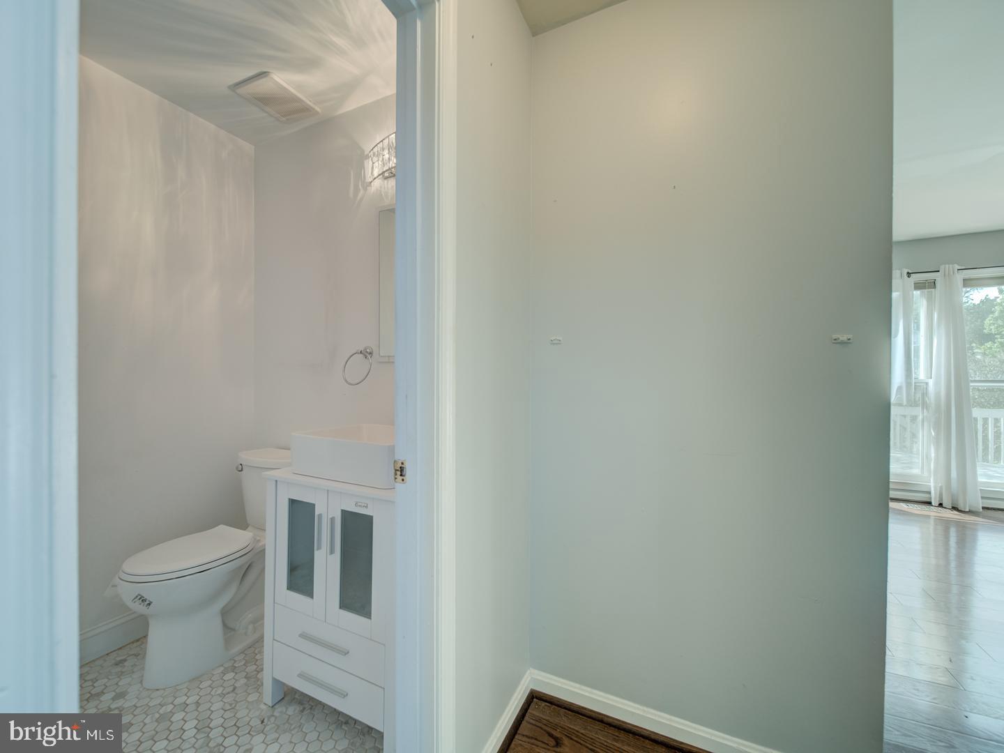 9618 Clover Hill Road Manassas, VA 20110 - Photo 13 of 61 a white toilet sitting next to a white sink and vanity