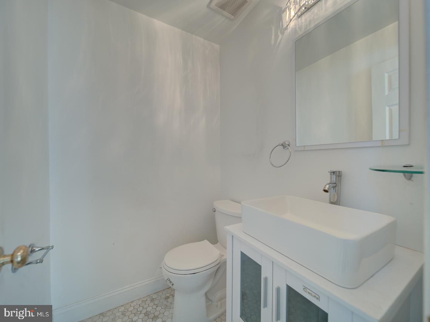 9618 Clover Hill Road Manassas, VA 20110 - Photo 14 of 61 a bathroom with a sink and a toilet