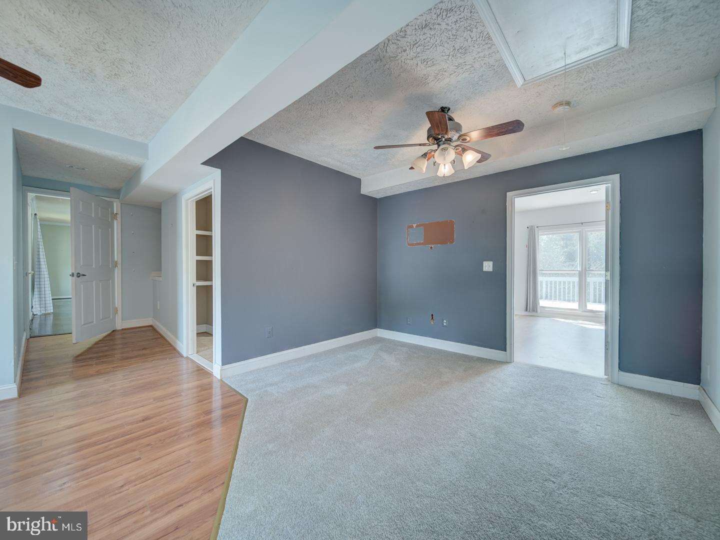 9618 Clover Hill Road Manassas, VA 20110 - Photo 18 of 61 a view of a room with a chandelier fan and wooden floor