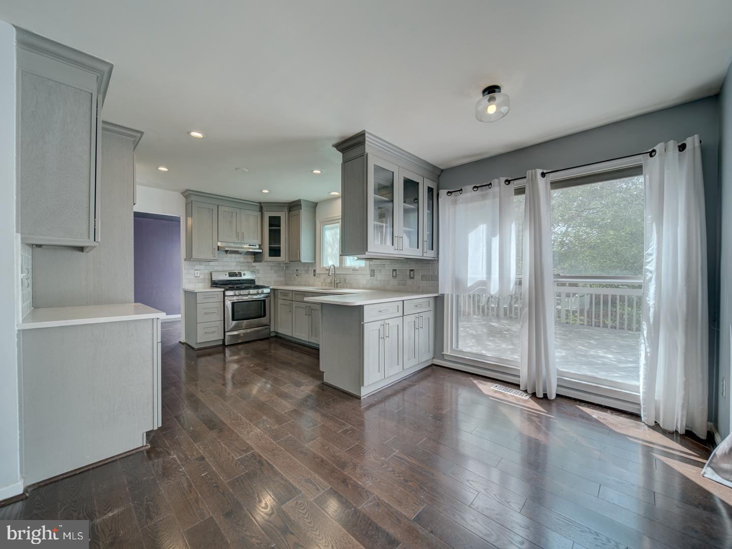 9618 Clover Hill Road Manassas, VA 20110 - Photo 23 of 61 a kitchen with stainless steel appliances granite countertop a refrigerator oven a sink and dishwasher with a large window