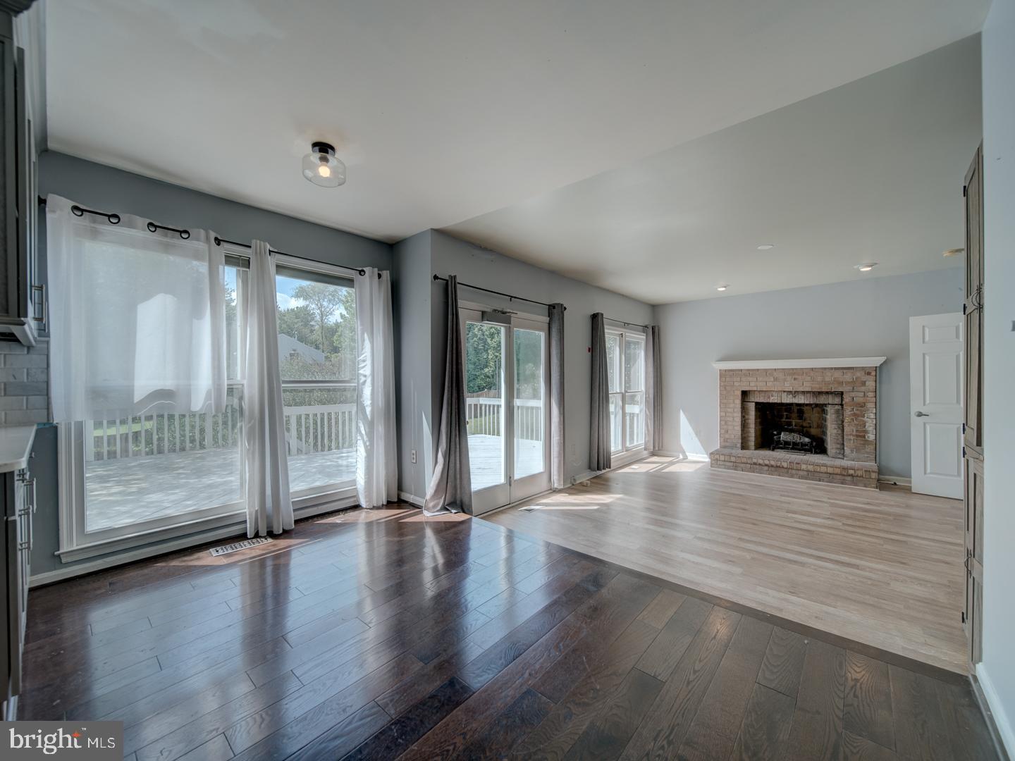 9618 Clover Hill Road Manassas, VA 20110 - Photo 25 of 61 a view of an empty room with wooden floor and a fireplace