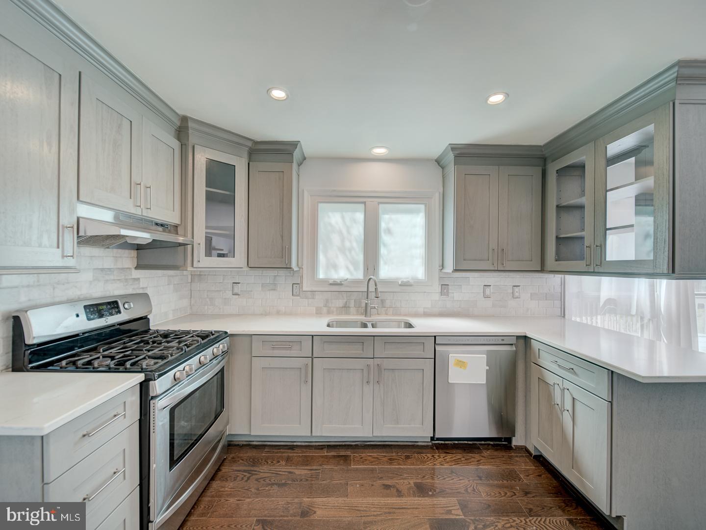 9618 Clover Hill Road Manassas, VA 20110 - Photo 27 of 61 a kitchen with a sink stove and cabinets