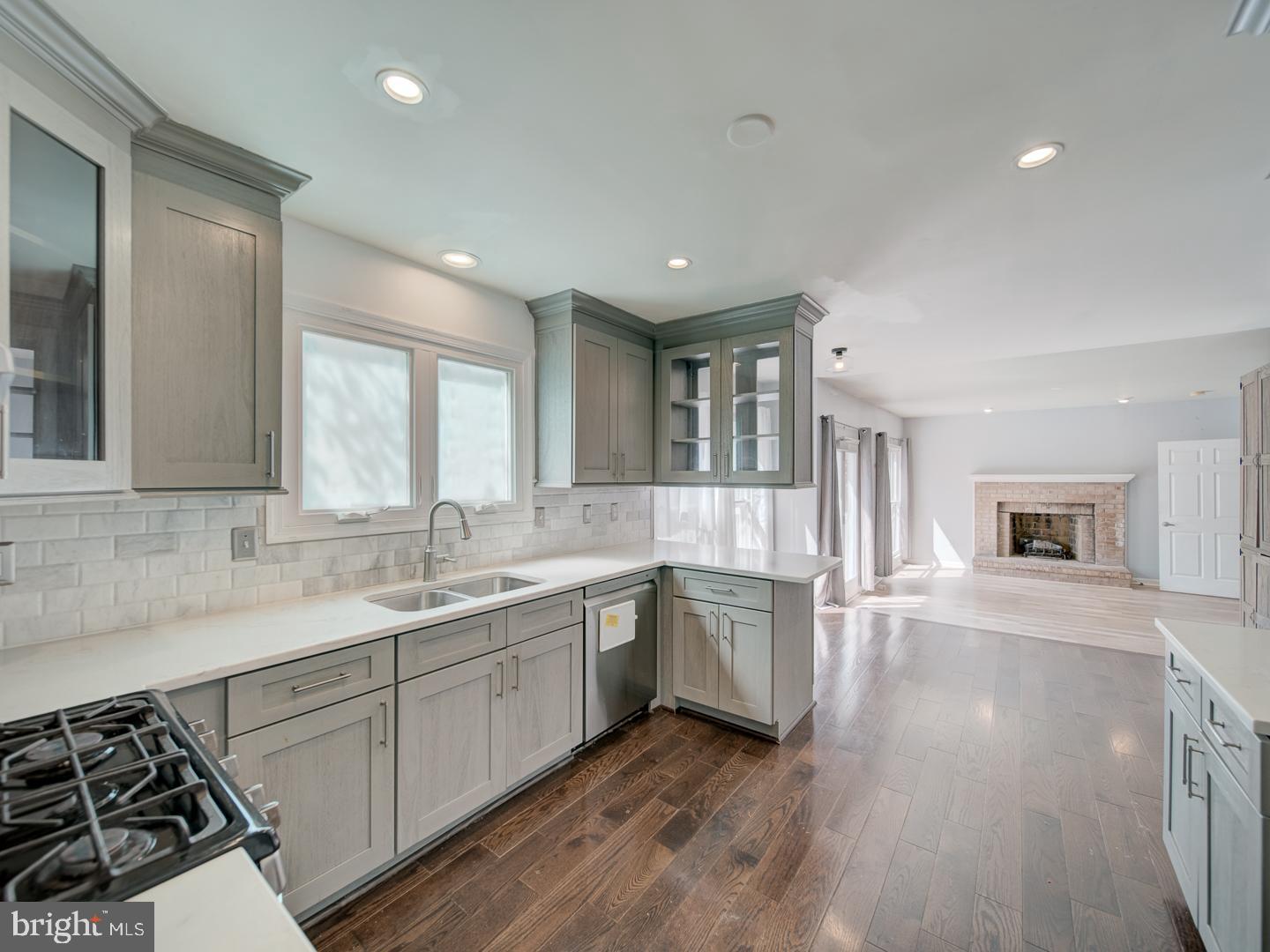 9618 Clover Hill Road Manassas, VA 20110 - Photo 28 of 61 a large white kitchen with stainless steel appliances granite countertop a sink and dishwasher a stove with wooden floor