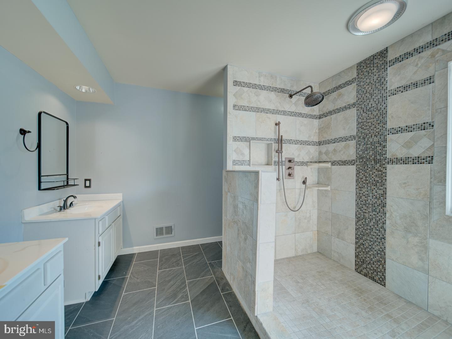 9618 Clover Hill Road Manassas, VA 20110 - Photo 40 of 61 a bathroom with a double vanity sink a mirror and a bathtub