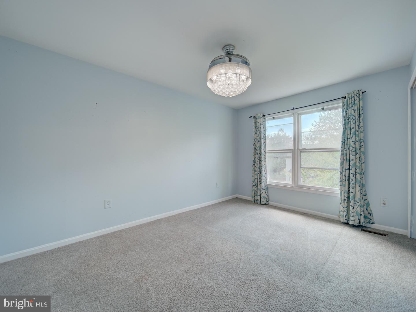 9618 Clover Hill Road Manassas, VA 20110 - Photo 47 of 61 an empty room with a clock and a window