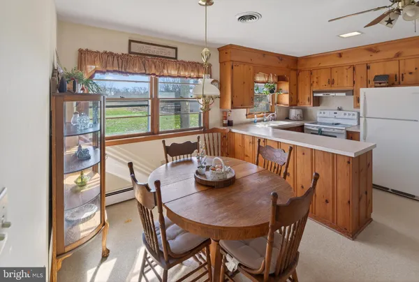 a view of a dining room with furniture a livingroom and chandelier