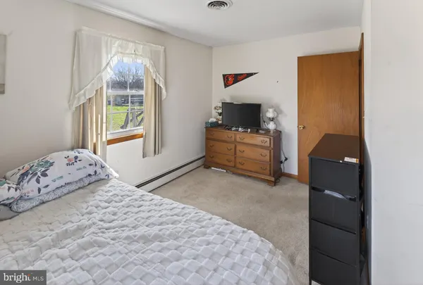 a bedroom with a bed and a window