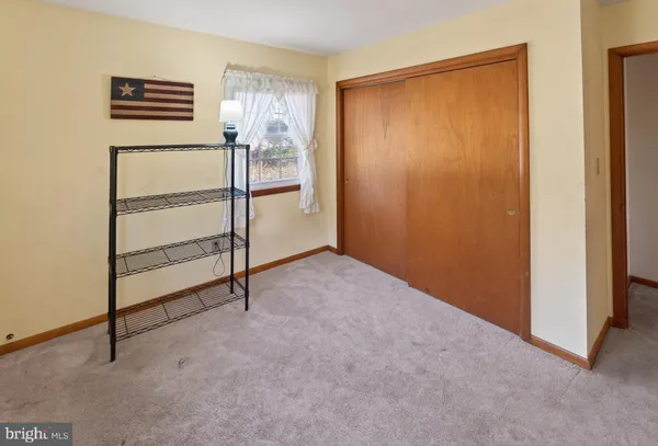 a view of an empty room with a closet