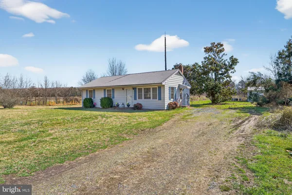 a front view of a house with a yard table and chairs