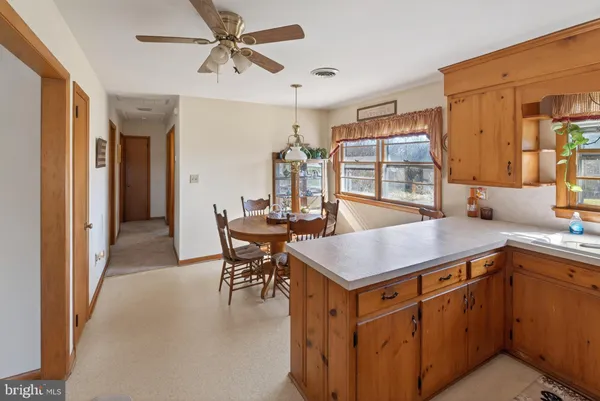 a dining hall with stainless steel appliances granite countertop a sink and a refrigerator