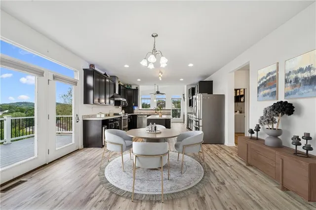 a kitchen with stainless steel appliances kitchen island granite countertop a stove top oven and sink