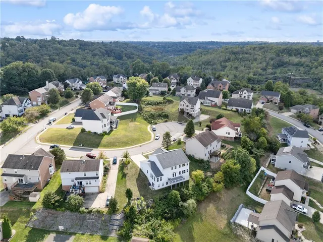 an aerial view of a house with a yard and garden