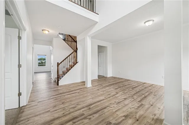 a view of entryway and hall with wooden floor
