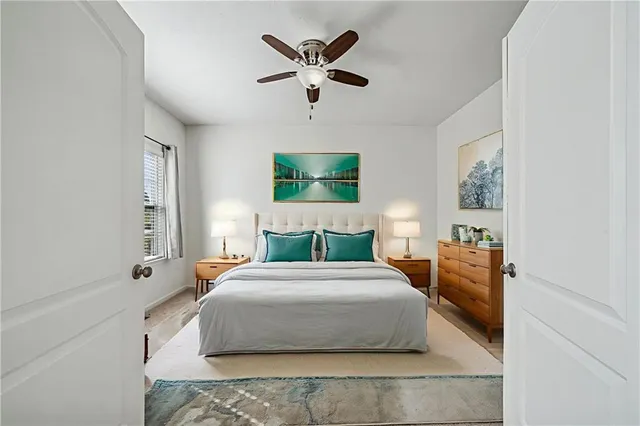 a bedroom with a large bed and a chandelier