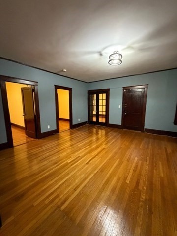 466 Locust Street, Unit 2 Fall River, MA 02720 - Photo 2 of 10 a view of an empty room with wooden floor and a window