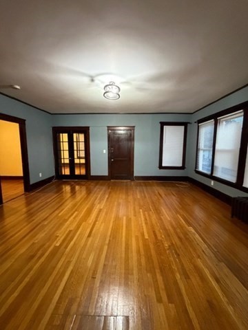 466 Locust Street, Unit 2 Fall River, MA 02720 - Photo 8 of 10 an empty room with wooden floor and windows