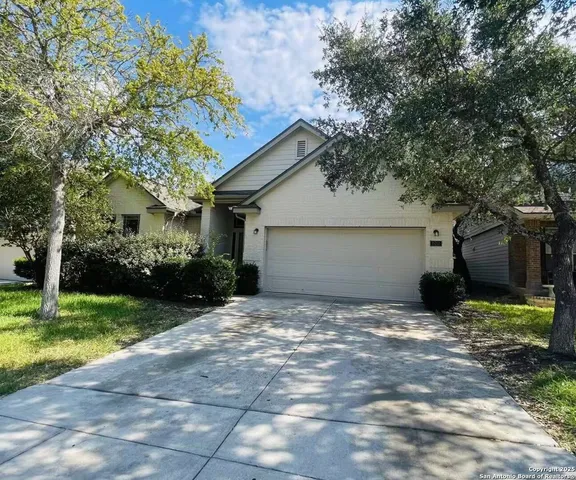 a view of a house with a yard and garage