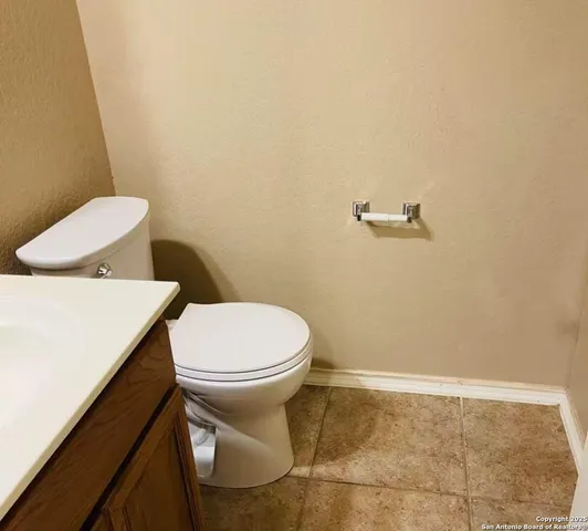 a white toilet sitting next to a bathroom sink