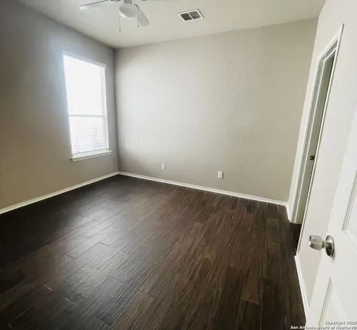a view of a room with wooden floor and window