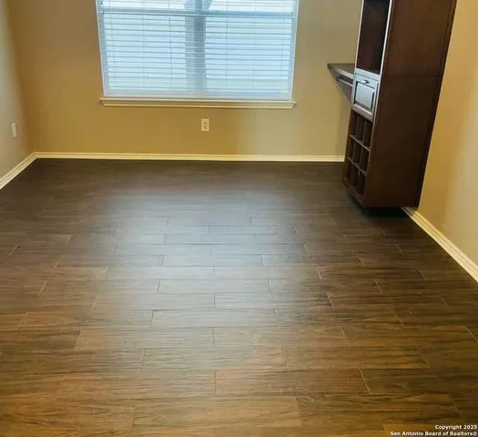 a view of an empty room and a window