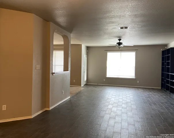 an empty room with windows and closet
