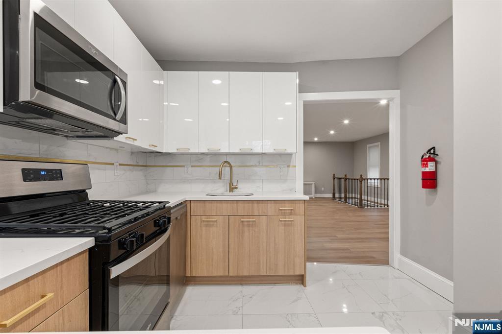 76 Mission Street Montclair, NJ 07042 - Photo 16 of 50 a kitchen with stainless steel appliances granite countertop a stove and a sink
