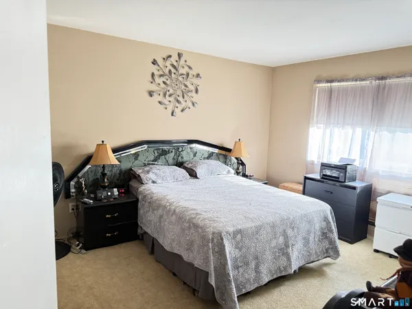 a bedroom with a bed and window