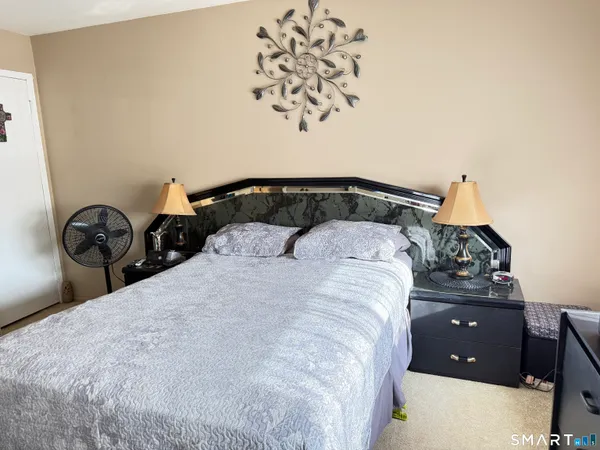 a bedroom with a bed and a chandelier