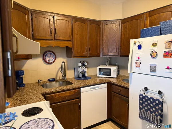 a kitchen with a refrigerator and a stove top oven