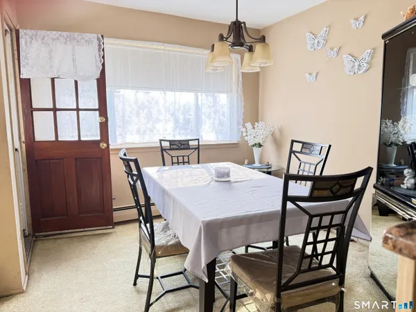 a view of a dining room with furniture window and outside view
