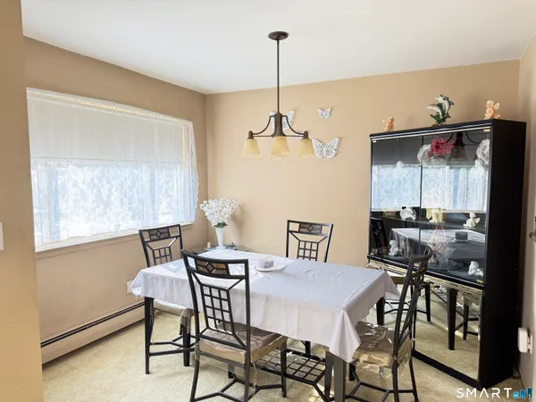 a view of a dining room with furniture and window