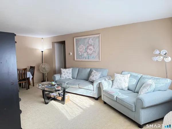 a living room with furniture and a lamp