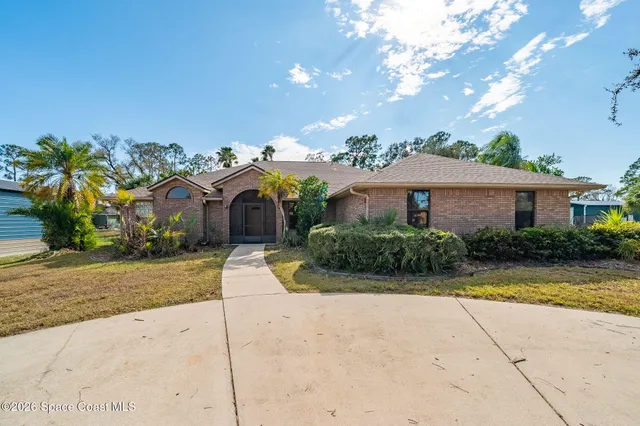 a front view of a house with a yard and a garage
