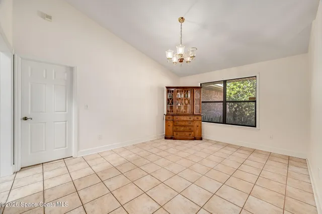 a view of a room with wooden floor and a ceiling fan