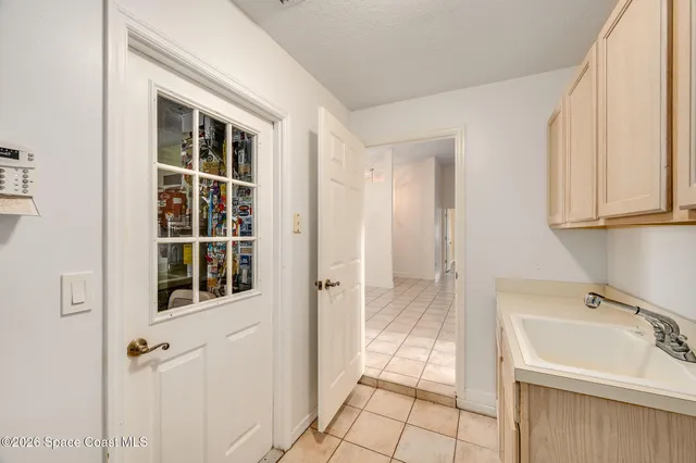 an empty room with a window and a ceiling fan