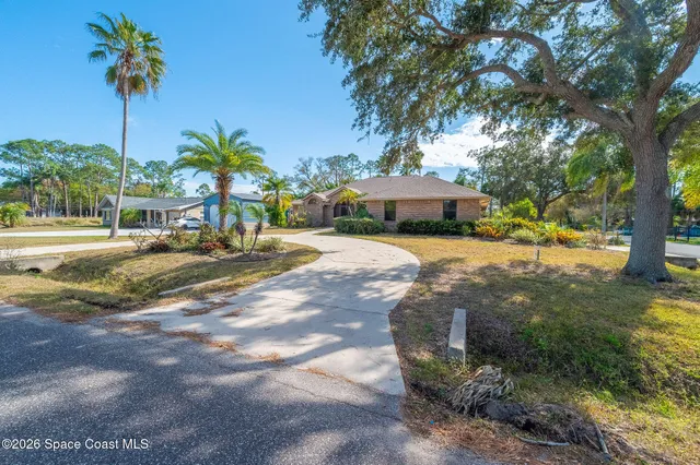 a view of a house with a yard and sitting area