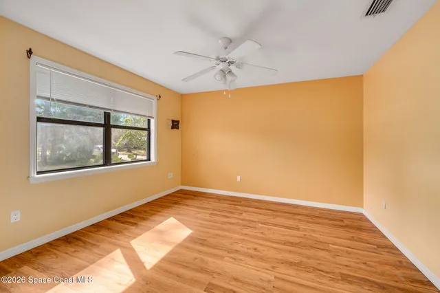 a dining room with furniture a chandelier and wooden floor