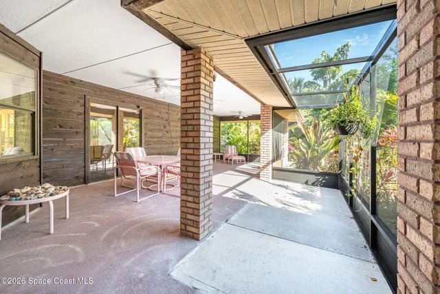 a view of a patio with table and chairs potted plants