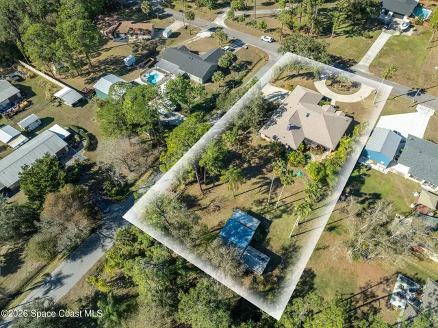 an aerial view of a house with a yard and garden