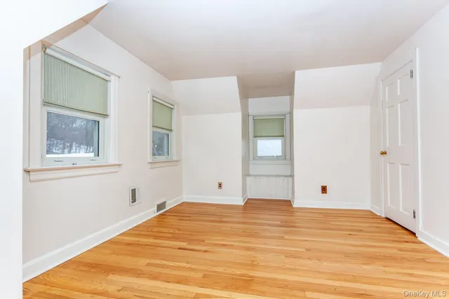 a view of a room with wooden floor and cabinet
