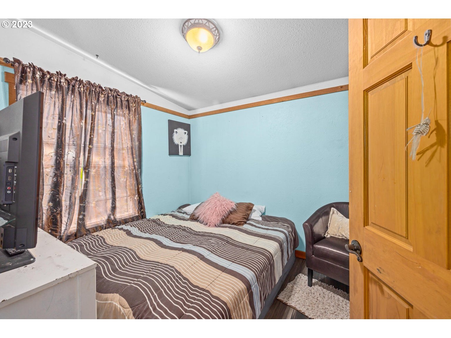 7546 South Prairie Road Tillamook, OR 97141 - Photo 26 of 36 a bedroom with a bed and a window