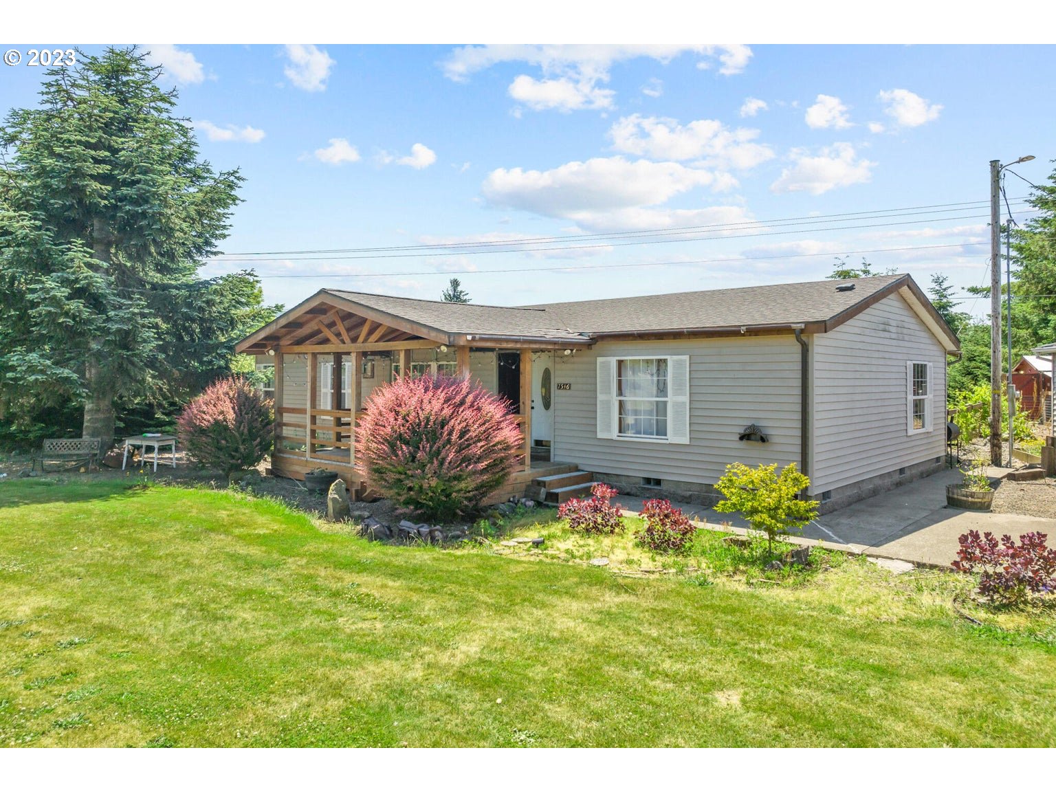 7546 South Prairie Road Tillamook, OR 97141 - Photo 3 of 36 a front view of a house with garden