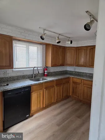 a kitchen with granite countertop a sink cabinets and window