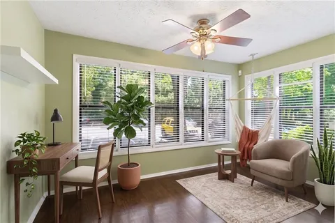 a living room with furniture and a potted plant